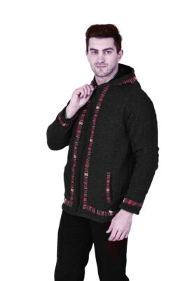 A man models the Aruna Kullu Handloom Woolen Winter Wear Zipper Hoodie Jacket for Men in grey, standing against a white background and holding the zipper near his neck.