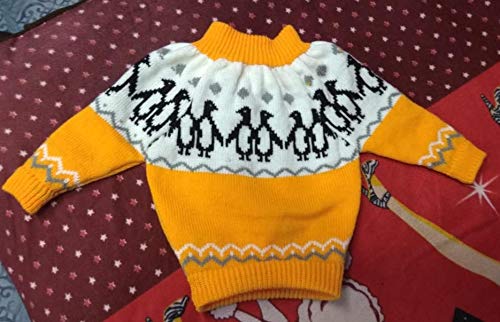 The aruna kullu handloom PURE WOOL HAND KNITTED FULL SLEEVE SWEATER in yellow, featuring black penguin motifs and diamond borders, is ideal winter wear for baby boys. Shown flat on a maroon patterned surface.