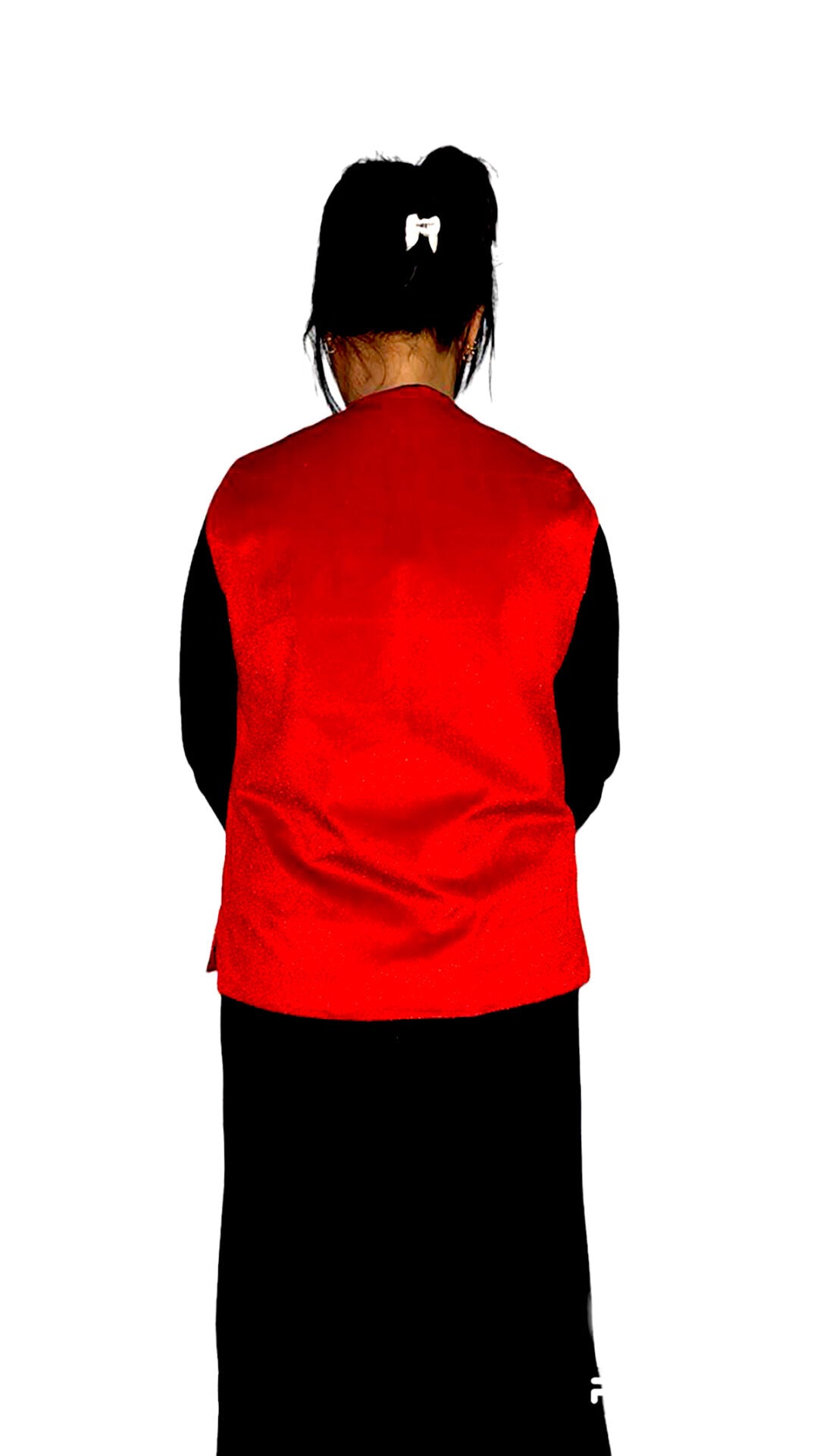 A person with long dark hair in a ponytail and a white hair tie is seen from the back, wearing an aruna kullu handloom Nehru jacket for women in red color over a black shirt and skirt, standing against a white background.