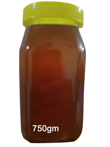 A clear plastic jar of Himachali Wild honey Raw honey by aruna kullu handloom, sealed with a yellow lid and labeled 750gm at the bottom.