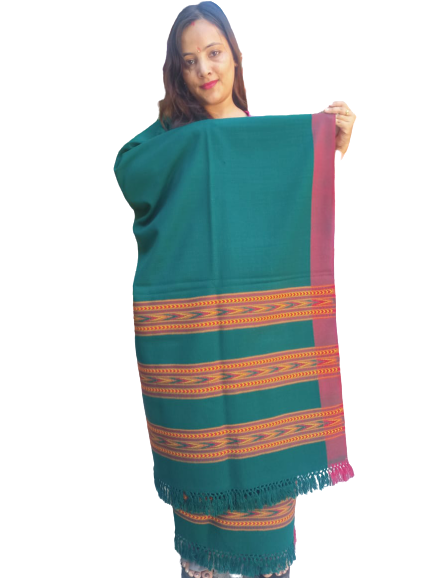 A woman holds an aruna kullu handloom ANGORA Shawl for women, featuring beautiful triple border Kullu weaving in green with red and yellow geometric patterns and fringed edges, set against a plain white background.