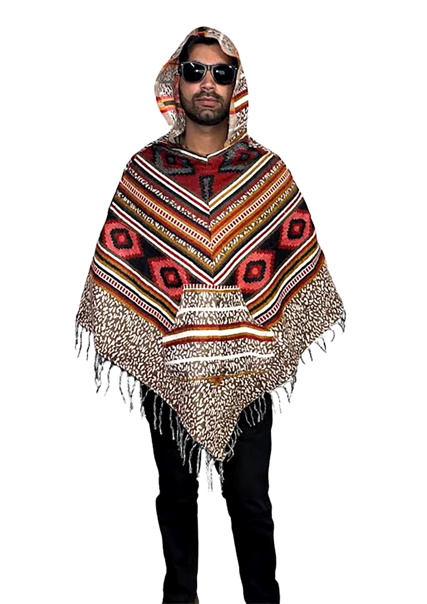 A man wears the aruna kullu handloom kullu shawl woolen poncho with hood multinew, featuring a colorful, bohemian-inspired pattern and fringe, standing against a white background.