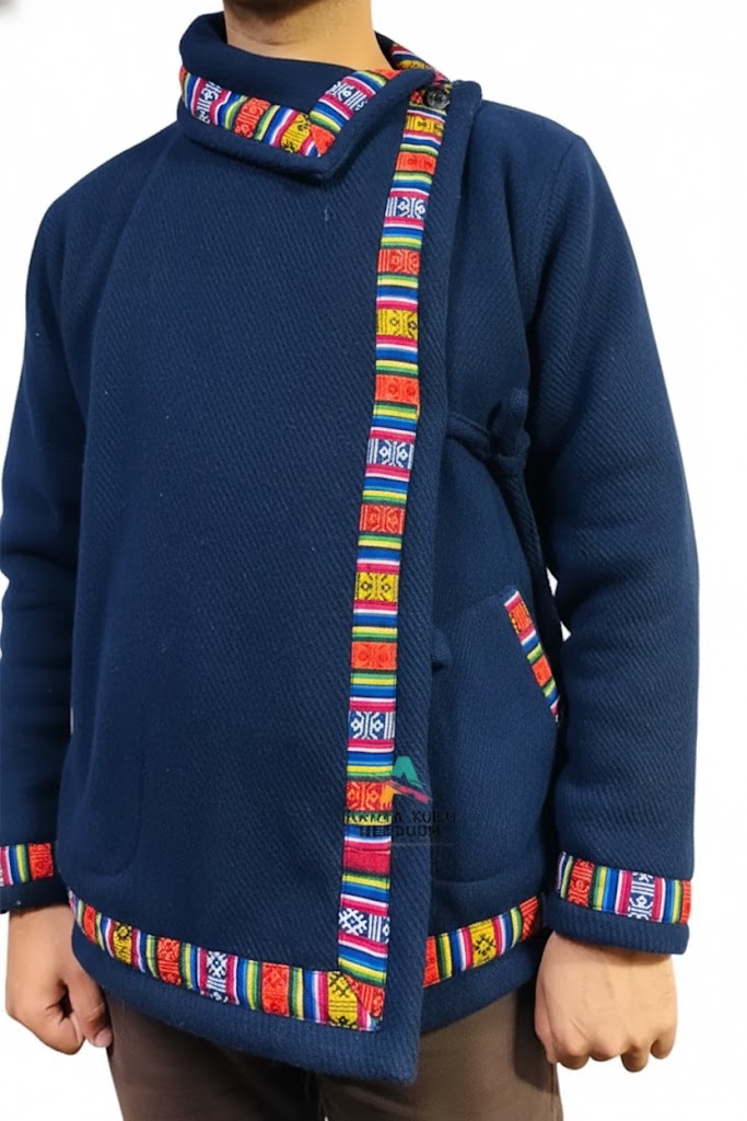 A person wears the aruna kullu handloom Kullu hoodie Nepali hoodie blue, a dark blue hand-woven jacket with colorful geometric trim on the collar, front, pockets, and hem. Inspired by traditional Kullu styles. Background is plain white.Kullu hoodie kullu hoodie online wool hoodies kullu lace hoodie kullu patti hoodie