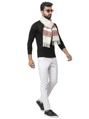 A man sports sunglasses, a black long-sleeve shirt, white pants, black shoes, and the aruna kullu handloom warm muffler Woollen Hand Woven Pure Embroidered white 3 patti while walking confidently against a white background.