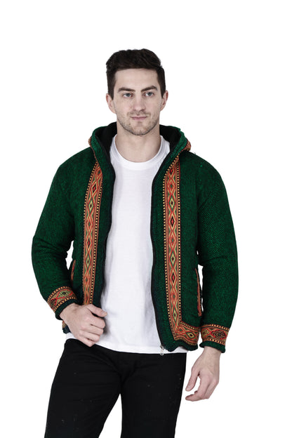 himachali hoodie for men kullu hoodie himachali hoodie kullu hoodie for men kullu hoodie for men  A man wears the aruna kullu handloom Woolen Winter Wear ZIPPER HOODIE in green with a patterned border, styled over a white t-shirt and black pants, standing against a white background.