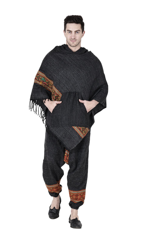 A person wearing the aruna kullu handloom Combo pajama and poncho black singal patti, featuring colorful handwoven embroidery, stands facing forward against a white background.