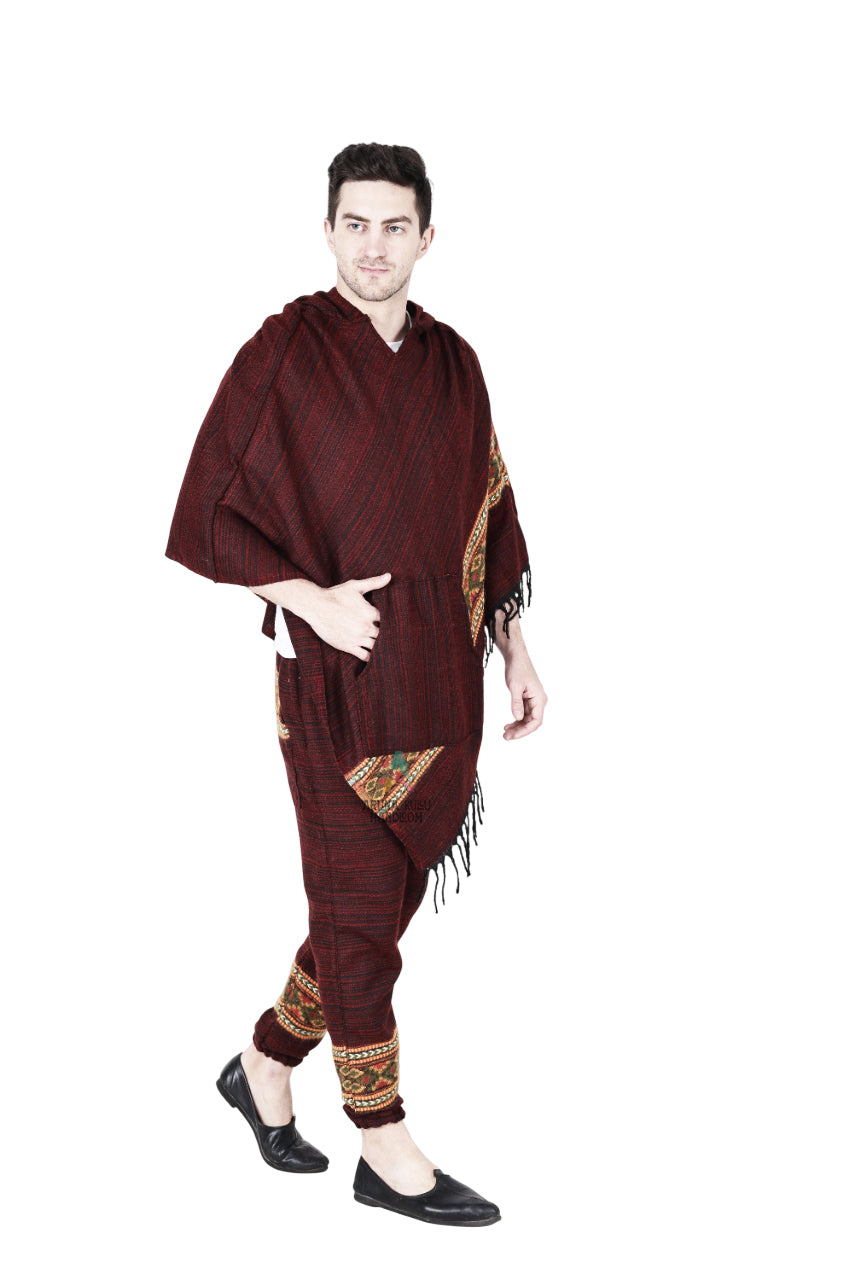 A person models the aruna kullu handloom Combo poncho and pajama maroon set with handwoven colorful embroidery, walking forward and looking to the side against a white background.