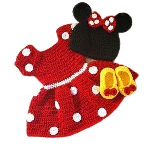 The "woolen baby set 0-12 months" by aruna kullu handloom features a red crocheted dress with white polka dots, a black hat with mouse ears and a red bow, and yellow shoes with red bows, inspired by a cartoon character.