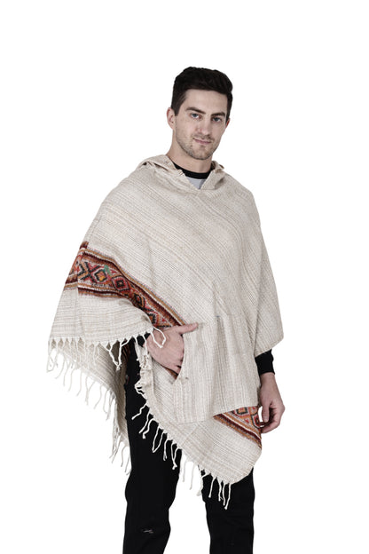 A man wears a white kullu shawl woolen poncho with hood, featuring fringe edges and red and brown hand-woven embroidery along the sides, set against a plain white background.