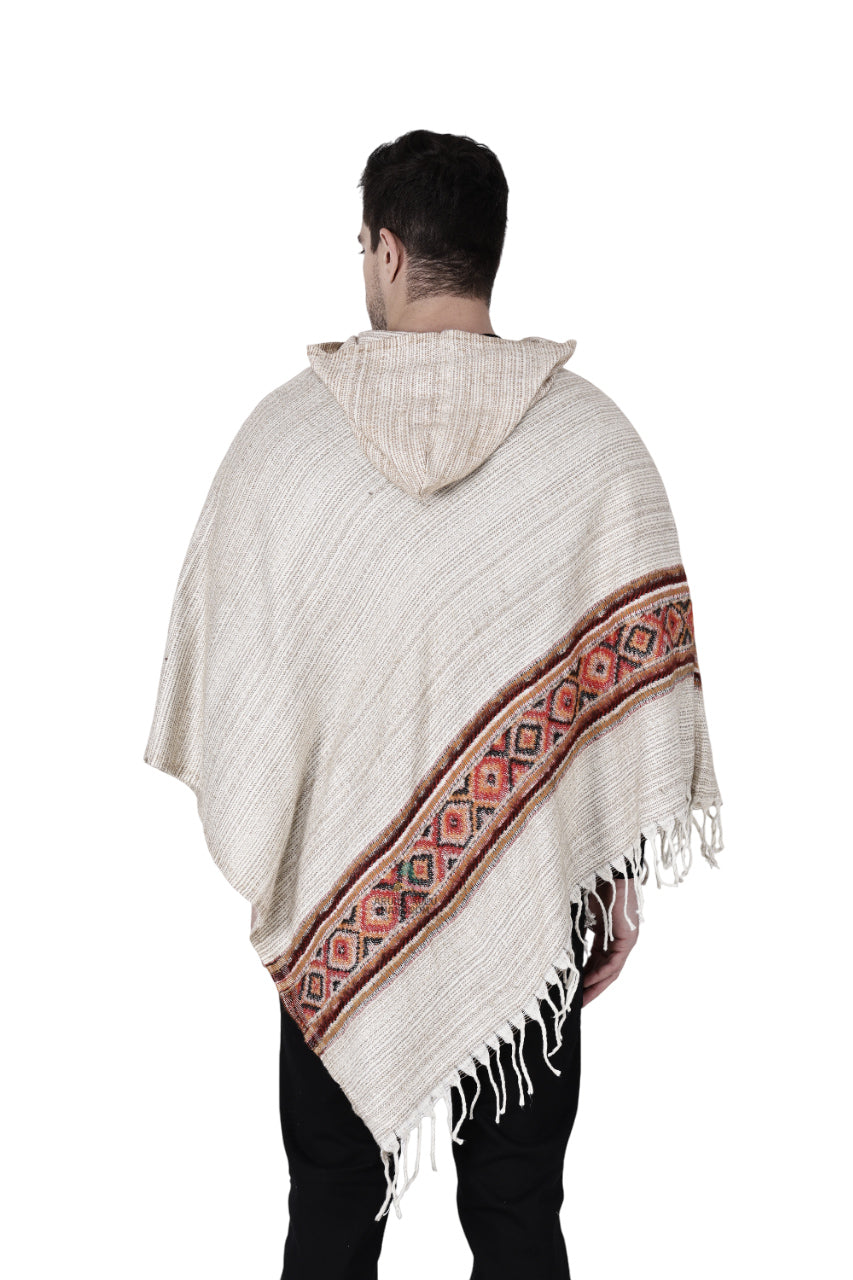 A person is seen from the back wearing the Kullu Shawl Woolen Poncho with Hood in white, featuring geometric stripe patterns and fringed edges, set against a white background.