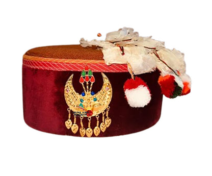 The aruna kullu handloom Artificial Handcrafted Himachali Kalgi for Himachali Topi features a decorative golden brooch with white feathers and colorful pom-poms, perfect for traditional maroon caps. Set against a white background.