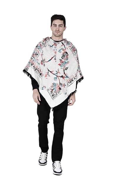 A man with short dark hair models the aruna kullu handloom Shimla jacket price kullu shawl woolen poncho with hood kashmiri silver over a black outfit, standing against a white background.Pahadi poncho for men pahadi kullu poncho mens kullu woolen poncho himachali poncho for men Himachali poncho online