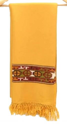 The aruna kullu handloom Kullu Kinnauri Handcrafted Shawl is a mustard yellow woolen shawl with fringed ends and a horizontal band of red, green, white, and yellow geometric patterns near one end, inspired by classic Kinnauri designs.