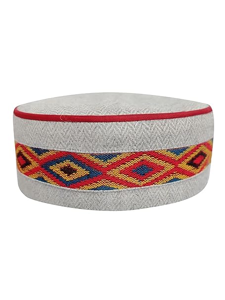 himachali topi pahadi topi uttarakhand topi   himachali cap kullu cap kullu topi  The "traditional kullu topi online mid grey centre border" by Aruna Kullu Handloom is a round, gray Himachali cap with red piping on the top edge and a colorful geometric embroidered band in yellow, red, and blue around the center.