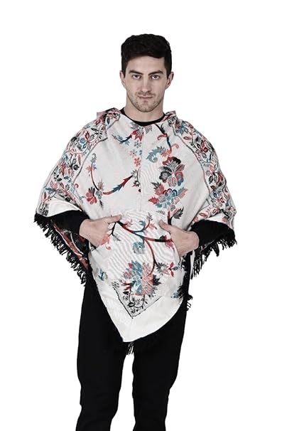 A man with short dark hair models the aruna kullu handloom Shimla jacket price kullu shawl woolen poncho with hood kashmiri silver over a black outfit, standing against a white background.Pahadi poncho for men pahadi kullu poncho mens kullu woolen poncho himachali poncho for men Himachali poncho online