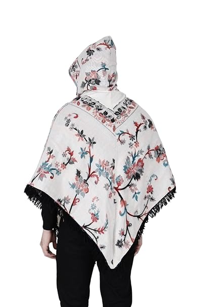 A man with short dark hair models the aruna kullu handloom Shimla jacket price kullu shawl woolen poncho with hood kashmiri silver over a black outfit, standing against a white background.Pahadi poncho for men pahadi kullu poncho mens kullu woolen poncho himachali poncho for men Himachali poncho online