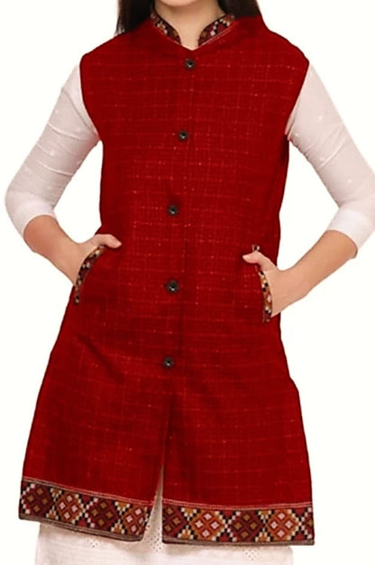 A woman wears the ARUNA KULLU HANDLOOM woolen winter long jacket in check blue with half sleeves, layered over a white top. Inspired by traditional Himachal Pradesh dress. The aruna kullu handloom brand; face not visible.