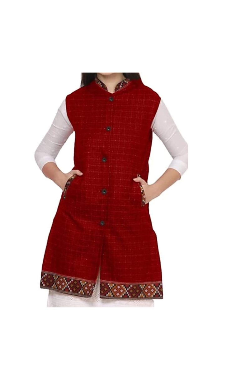 A woman poses with hands in her pockets, wearing the aruna kullu handloom Check red long jacket with kullu lace work, styled over a white long-sleeve top and paired with a chic women's woolen half jacket.
