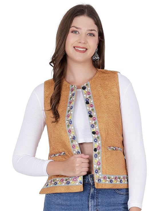 A woman with long brown hair smiles, wearing a white top, blue jeans, and an aruna kullu handloom Nehru jacket for women in yellow with embroidery work.