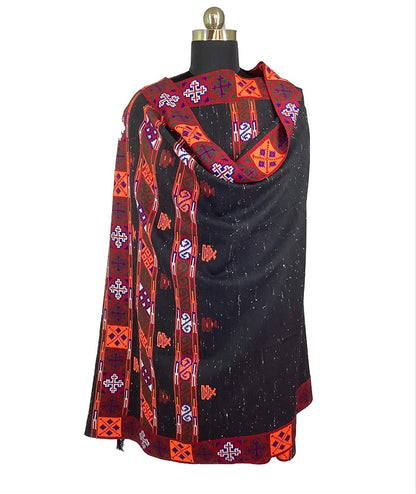 The Women's Yak Wool Kullu Kinnuari Triple Border Kullu Shawl Black by aruna kullu handloom features orange, red, and purple geometric and traditional patterns hand woven in Himachal Pradesh style, draped over a gold-topped mannequin.