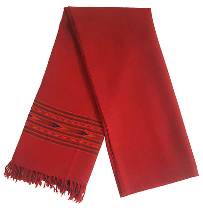 The ARUNA Premium Pure Wool Kullu Shawl Unisex by aruna kullu handloom is a red woven scarf with subtle stripes and patterns near one end and fringed tassels, neatly folded for an elegant look.