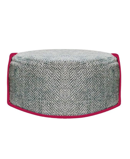kullu cap kullu cap price kullu cap online kullu cap design kullu cap wholesaleA round ottoman with a gray herringbone pattern and bright pink border, inspired by the aruna kullu handloom himachali cap Kullu Patti Woolen Topi/Cap with mor panja design, shown from the front on a white background.