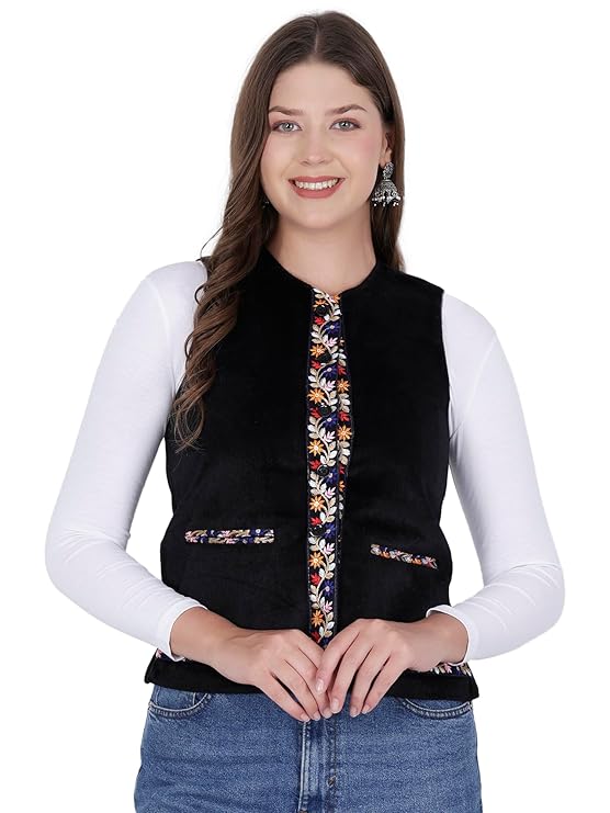 A woman wears the aruna kullu handloom Nehru jacket for women with embroidery work in black over a white long-sleeve top and blue jeans, smiling at the camera.