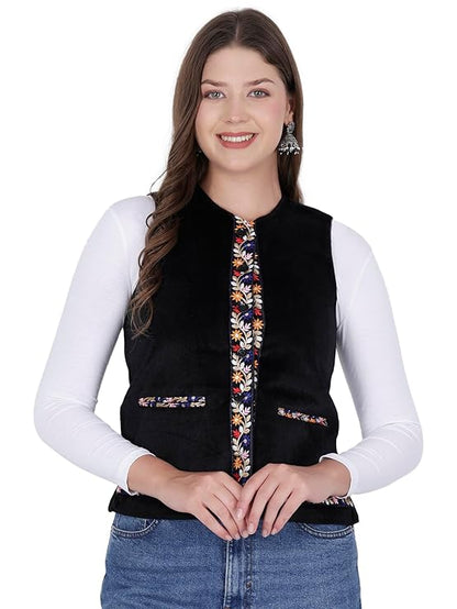 A woman wears the aruna kullu handloom Nehru jacket for women with embroidery work in black over a white long-sleeve top and blue jeans, smiling at the camera.