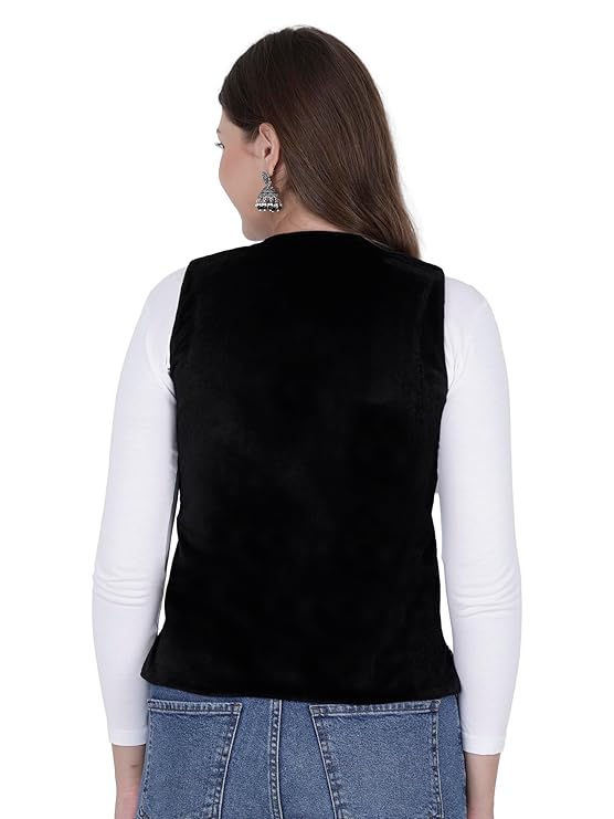 A woman with long brown hair is shown from the back against a white background, wearing blue jeans, silver earrings, a white long-sleeve top, and the "Nehru jacket women with embroidery work black" by aruna kullu handloom.