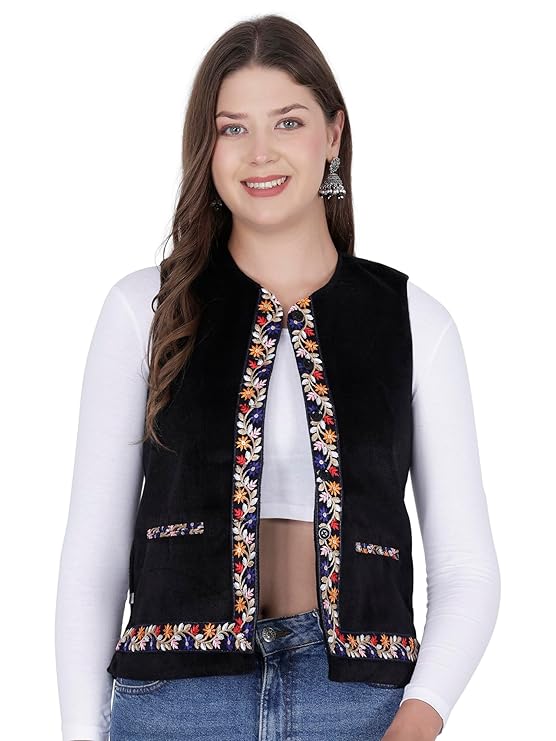 himachali jacket himachali sadri for ladies sadri for women kullu jacket for ladies winter sadri for women kullu jacket himachali half jacket for ladies  A smiling woman with long brown hair wears the aruna kullu handloom Nehru jacket for women in black, featuring embroidery work along the edges and pocket openings. She styles it over a white long-sleeve shirt and blue jeans.