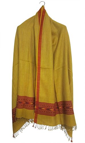 The ARUNA Premium Pure Wool Kullu Shawl Unisex by aruna kullu handloom in mustard yellow features a red and orange patterned border with fringed ends, shown hanging on a hook against a plain white background.