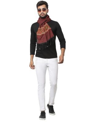 A man wears sunglasses, a black long-sleeve shirt, white pants, black shoes, and an aruna kullu handloom Kullu muffler Woollen Hand Woven Pure Embroidered maroon as he walks confidently against a white background.
