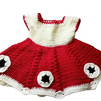 The woolen baby frock (0-12 months) from Aruna Kullu Handloom features a white bodice, red skirt, handwoven embroidery, and star-shaped accents—an adorable choice for your little one.