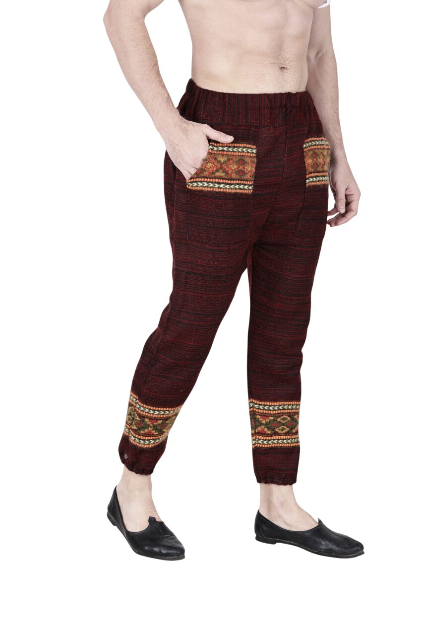 A man wearing aruna kullu handloom’s maroon Pajama for men, featuring patterned pockets and ankle designs, stands barefoot in a photo cropped at the torso.