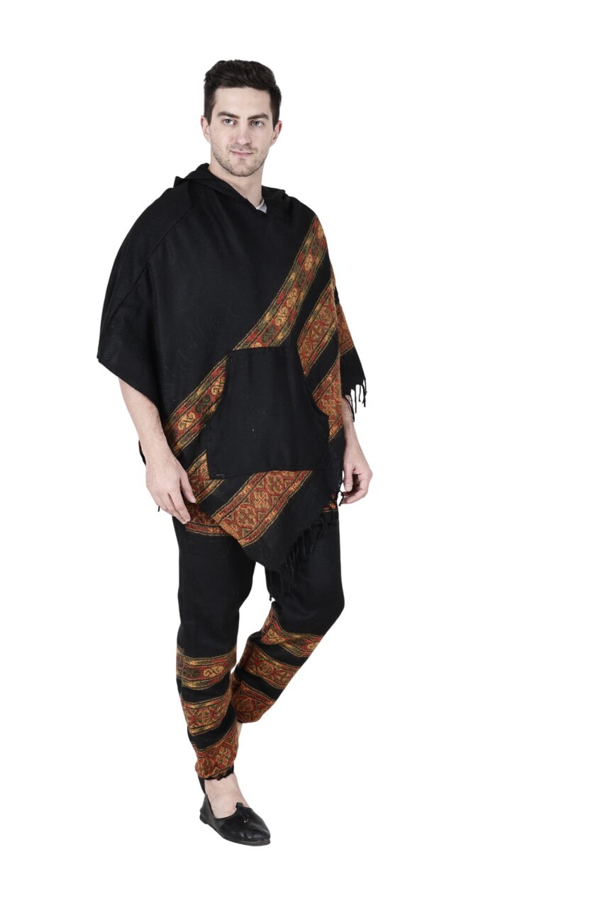 A man wears the Aruna Kullu Handloom "Combo pajama and poncho black 3 patti," featuring orange and gold accents. He stands against a plain white background, looking forward with a slight smile.