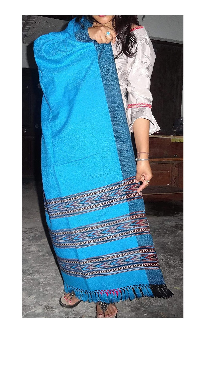 A person in a light shirt showcases the aruna kullu handloom ANGORA Shawl, featuring beautiful Kullu weaving in frozen color, ideal for women and girls. Stylish stripes and fringes highlight this handloom classic from Himachal Pradesh.