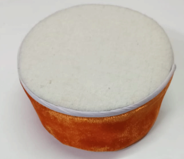 The aruna kullu handloom Pahari cap features a plush white top and saffron velvet sides, resembling the traditional Bhagwa color Himachali headwear, displayed on a white background.