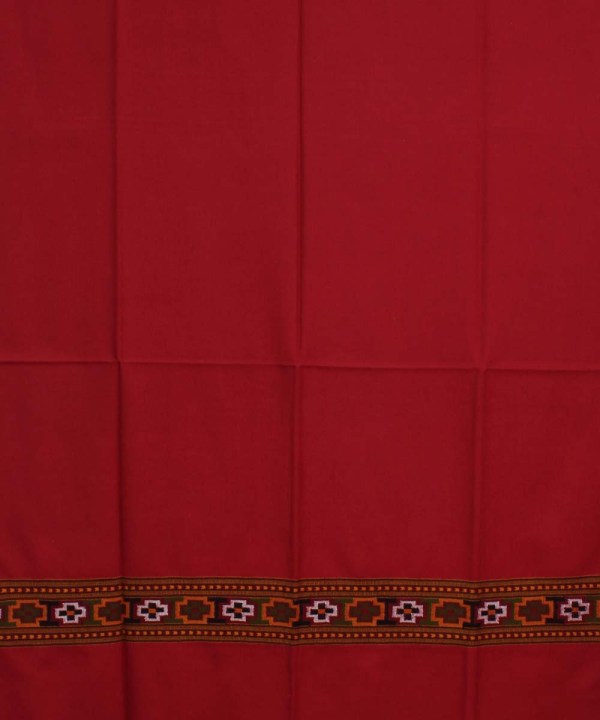 The aruna kullu handloom Kullu Kinnauri Handcrafted Shawl is a pure wool, handwoven women's shawl in solid red with fold lines and a patterned border of geometric shapes in orange, green, white, and black.