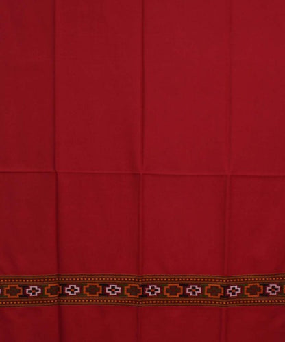 The aruna kullu handloom Kullu Kinnauri Handcrafted Shawl is a pure wool, handwoven women's shawl in solid red with fold lines and a patterned border of geometric shapes in orange, green, white, and black.
