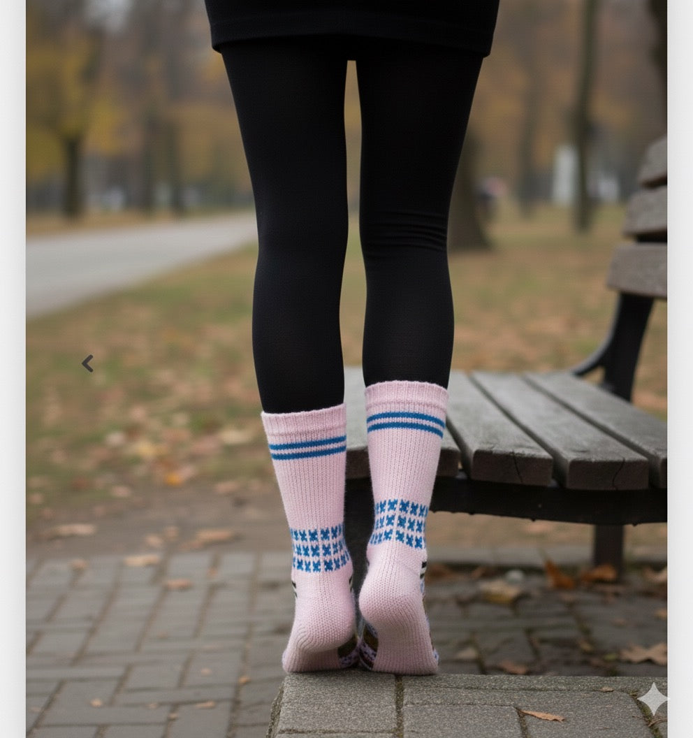 A person stands barefoot on a paved walkway by a park bench, wearing black leggings and aruna kullu handloom Woollen Traditional Hand Made Kullu Socks (Multicolour, Free Size) in pink; trees and a road are visible in the background.