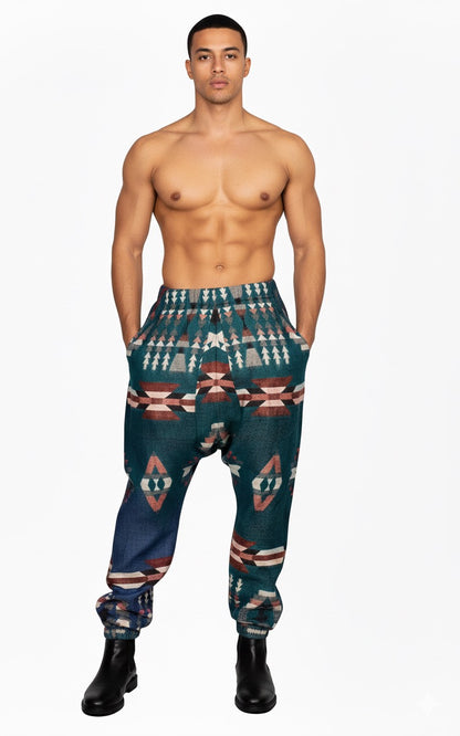 winter pajama for men mens pyjamas traditional loose cotton pyjamas for men mens pyjamas traditional pajama for men kullu pajama kullu pajama online himachali pajama for men  A shirtless man stands facing forward in aruna kullu handloom's wool super soft warm pajamas with Kullu Patti work yoga pajama green, hands in pockets, against a plain white background.