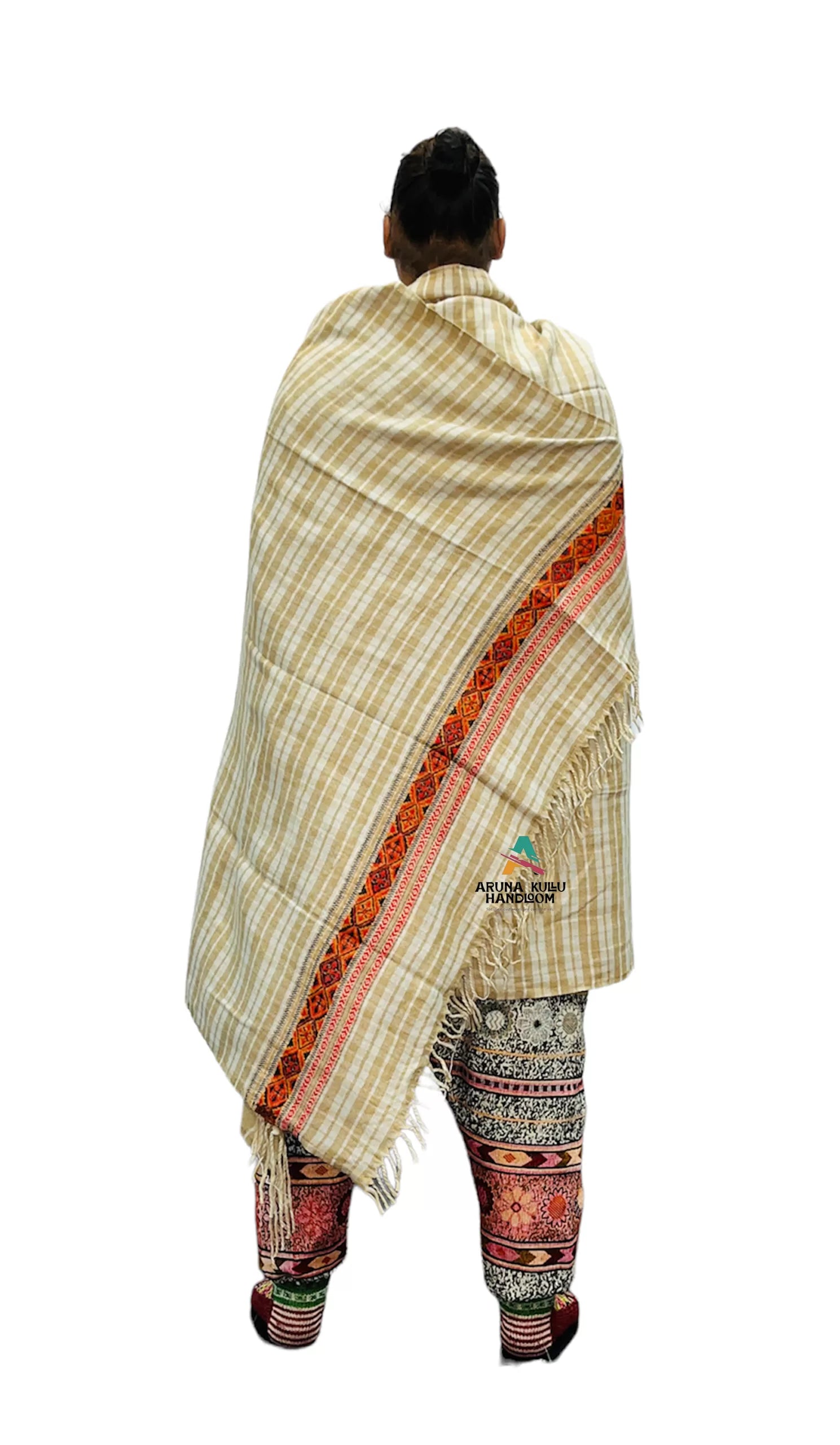 A person seen from behind wears colorful woven pants and the ARUNA Genuine Hand Woven Kullu Wool LOI Shawl—cream with check pattern and kullu patti work by aruna kullu handloom—draped over their shoulders, hair in a bun, against a white background.