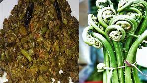 On the left is a plate of cooked fiddlehead ferns, and on the right is a bundle of fresh ones, both often used to make aruna kullu handloom's Lingdu Ka Achar- लिंगड़ू का अचार (Fiddlehead Ferns Pickle/Kasrod Ka Achar).