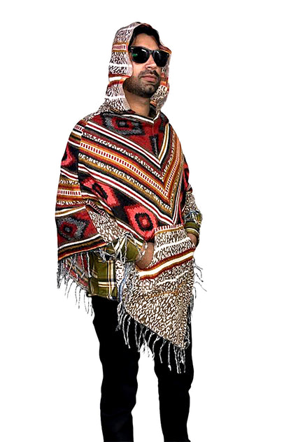 A man in an aruna kullu handloom "kullu shawl woolen poncho with hood multinew" pairs this vibrant bohemian poncho with black pants and sunglasses, offering a modern take on garba dress for men against a white background.