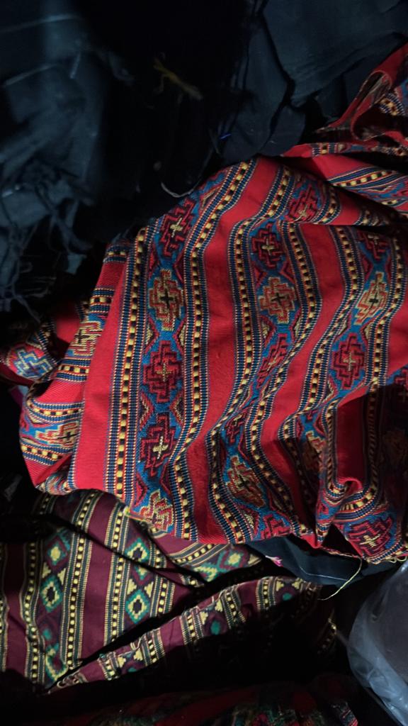 The aruna kullu handloom KULLU Patti (LACE) Border for Suits, Kurtis, and Dress Material (3 M) features vibrant red, blue, yellow, and green geometric patterns with a traditional design on intricately woven woolen fabric.