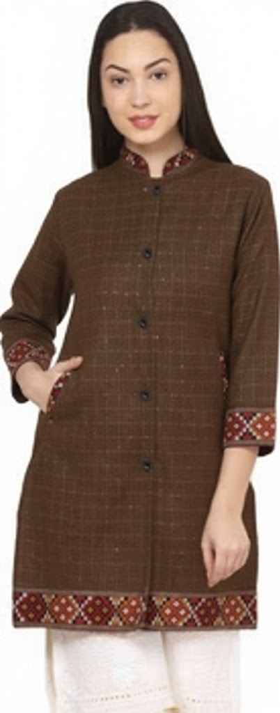 A woman wears an aruna kullu handloom himachali long jacket for ladies in brown check with full sleeves, styled traditionally with one hand in her pocket.